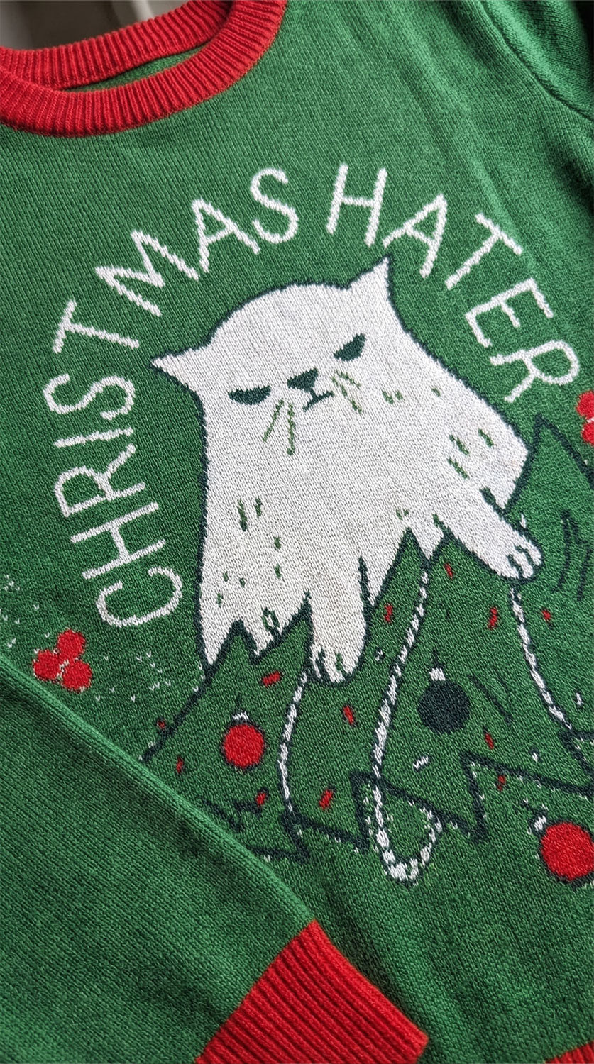Yūjin Clothing Christmas Hater Cat sweatshirt featuring a humorous design with a cat graphic and festive holiday theme.