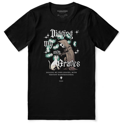 Yūjin Clothing Digging My Own Graves cat T-Shirt featuring a graphic of a cat digging with bold text on a black fabric background.